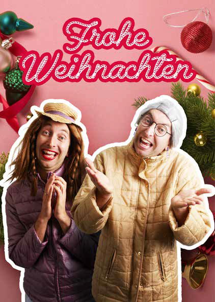 Helga und Marianna stehen vor weihnachtlichem Hintergrund und der Schrift "Frohe Weihnachten".