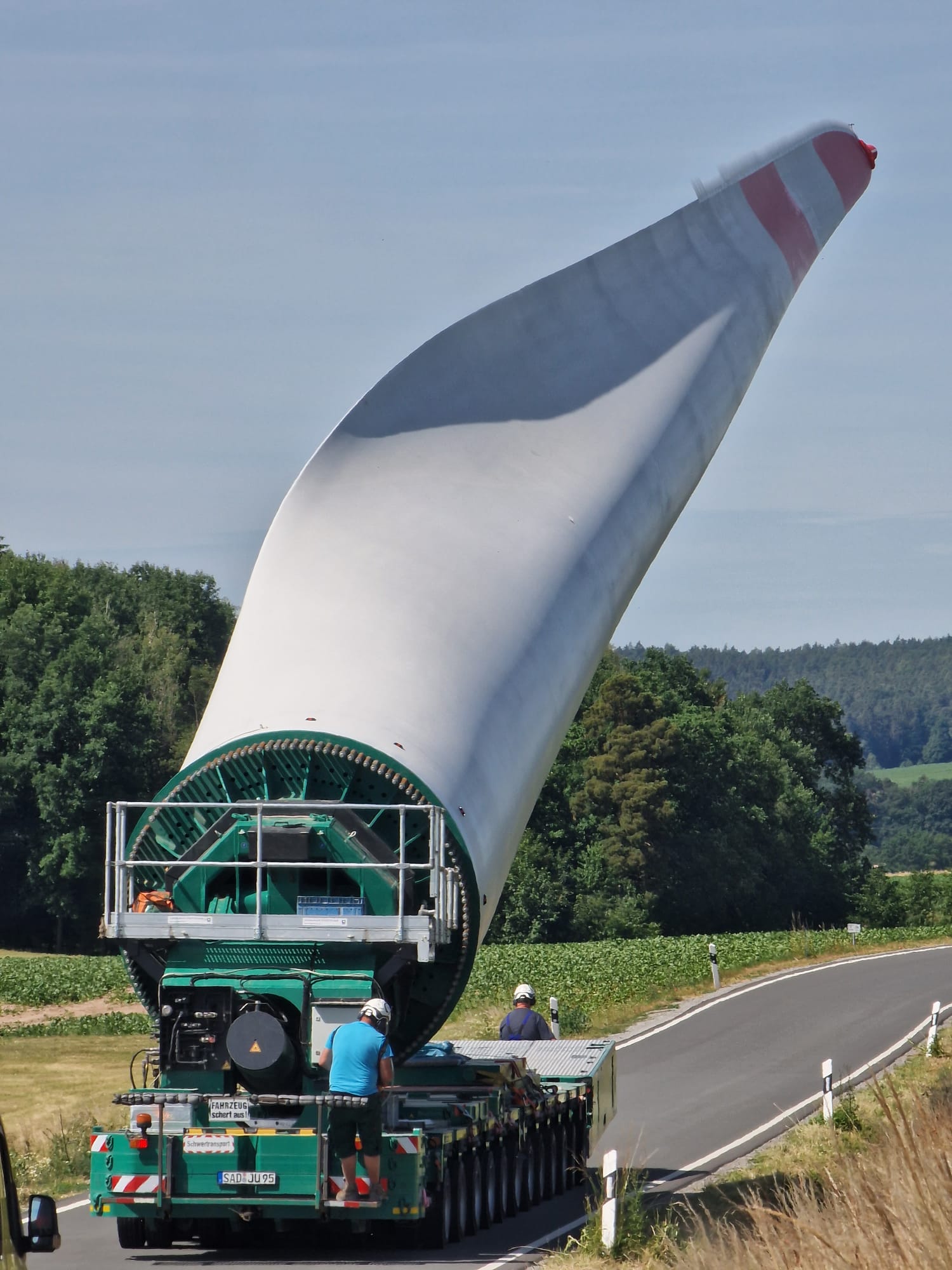 Ein Rotorflügel wird auf einem Anhänger transportiert.